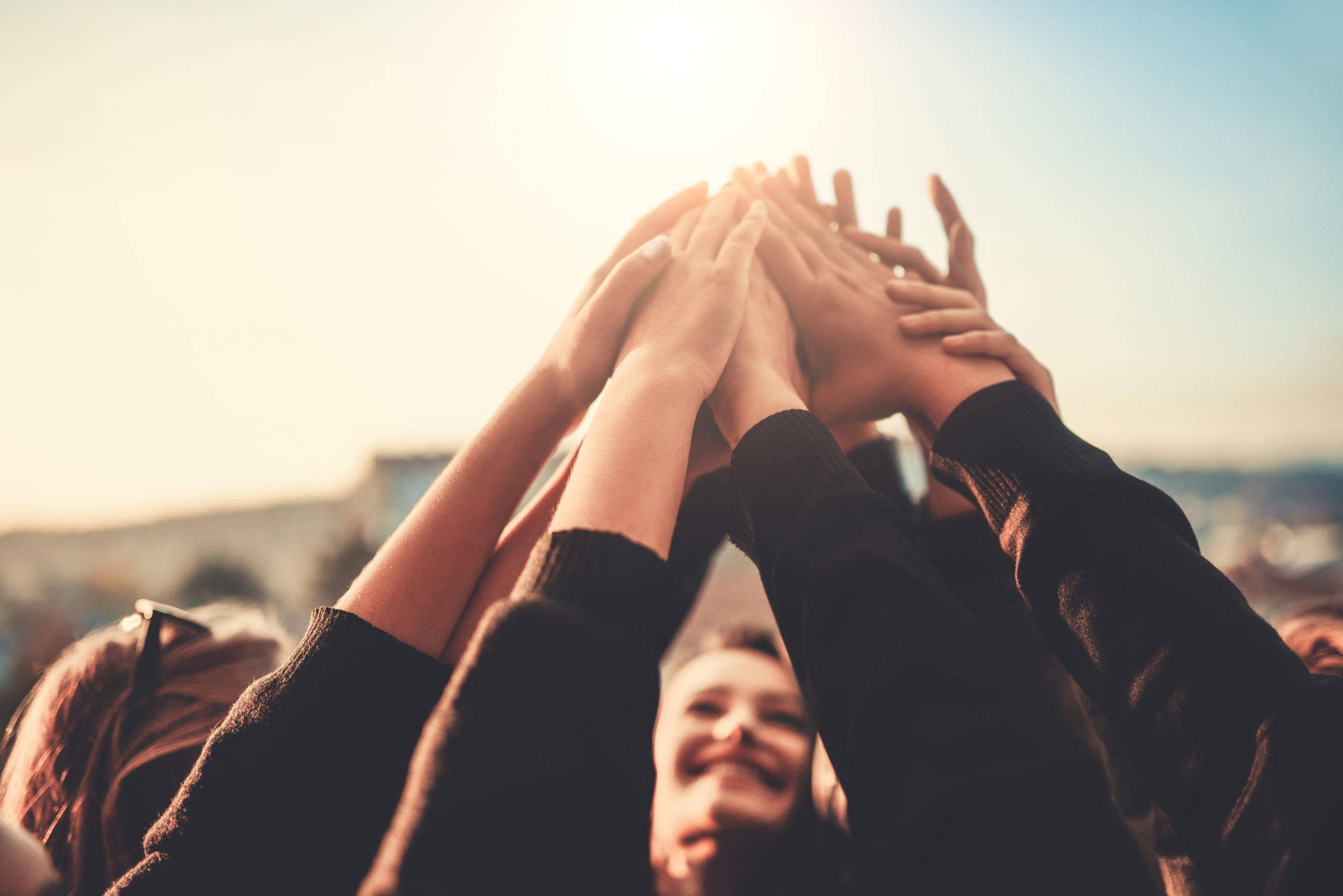 Group of Teenagers Volunteer with Raised Hands to the Sky