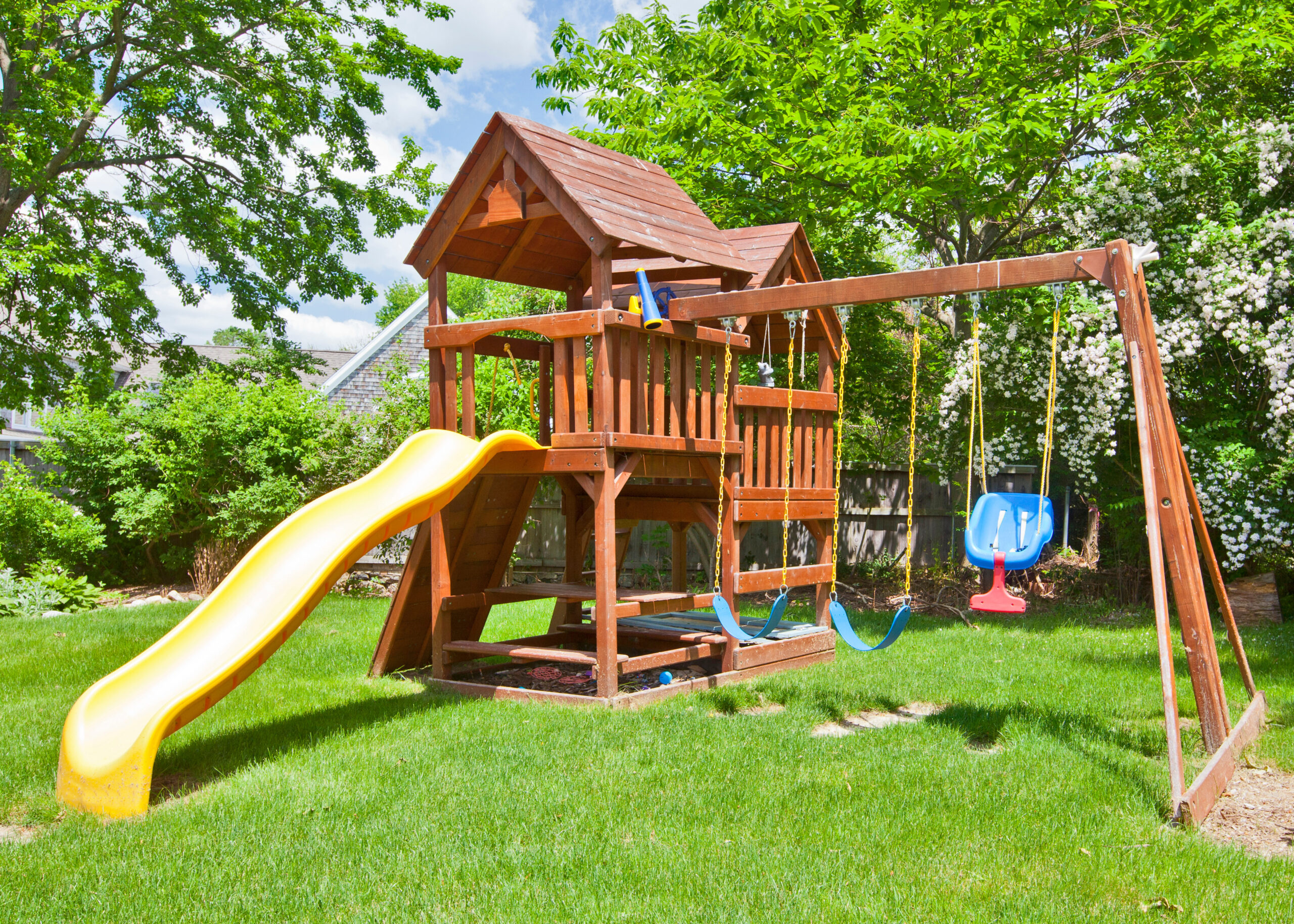 wooden swing set on green lawn