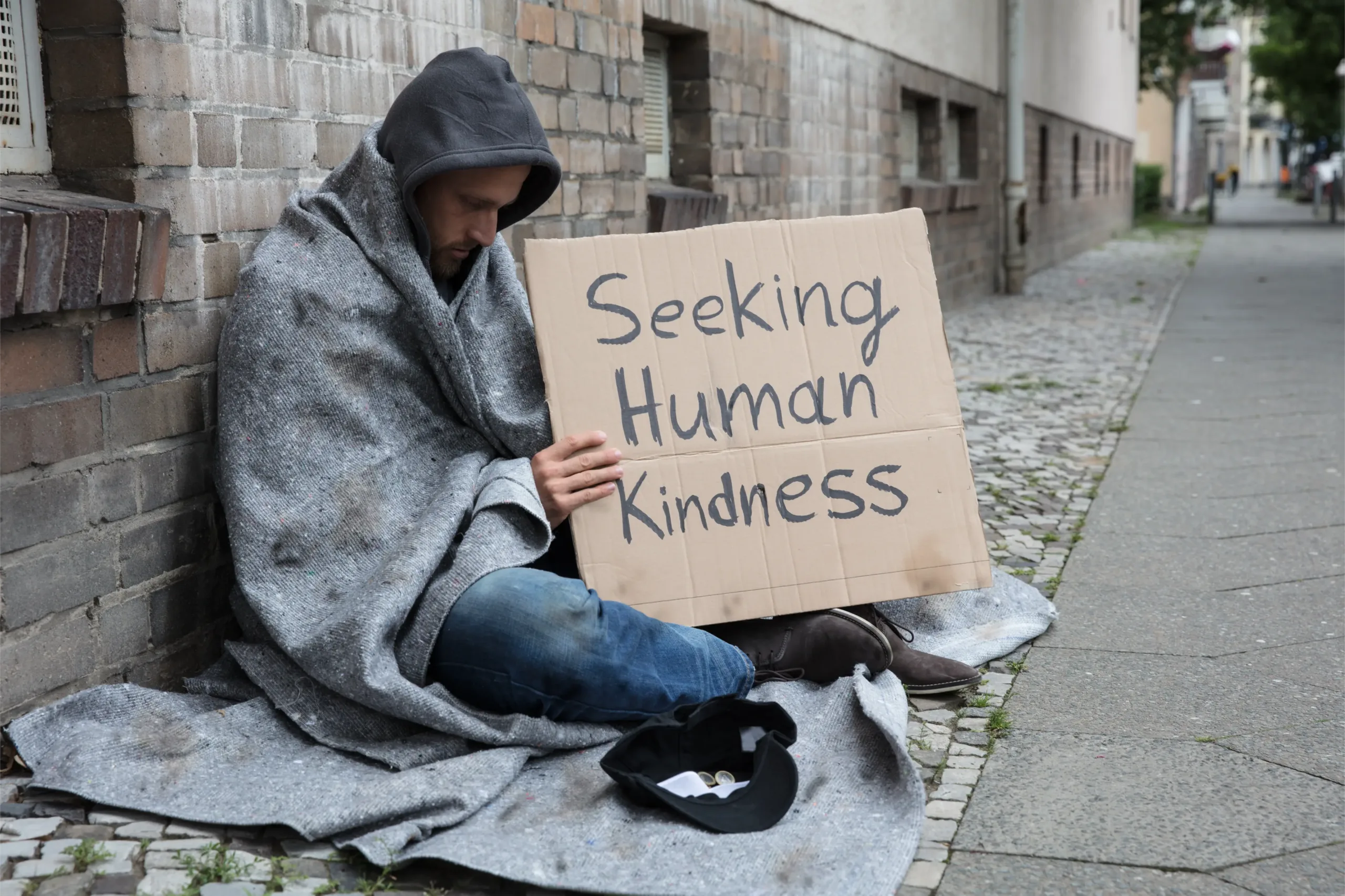 Homeless man holding sign