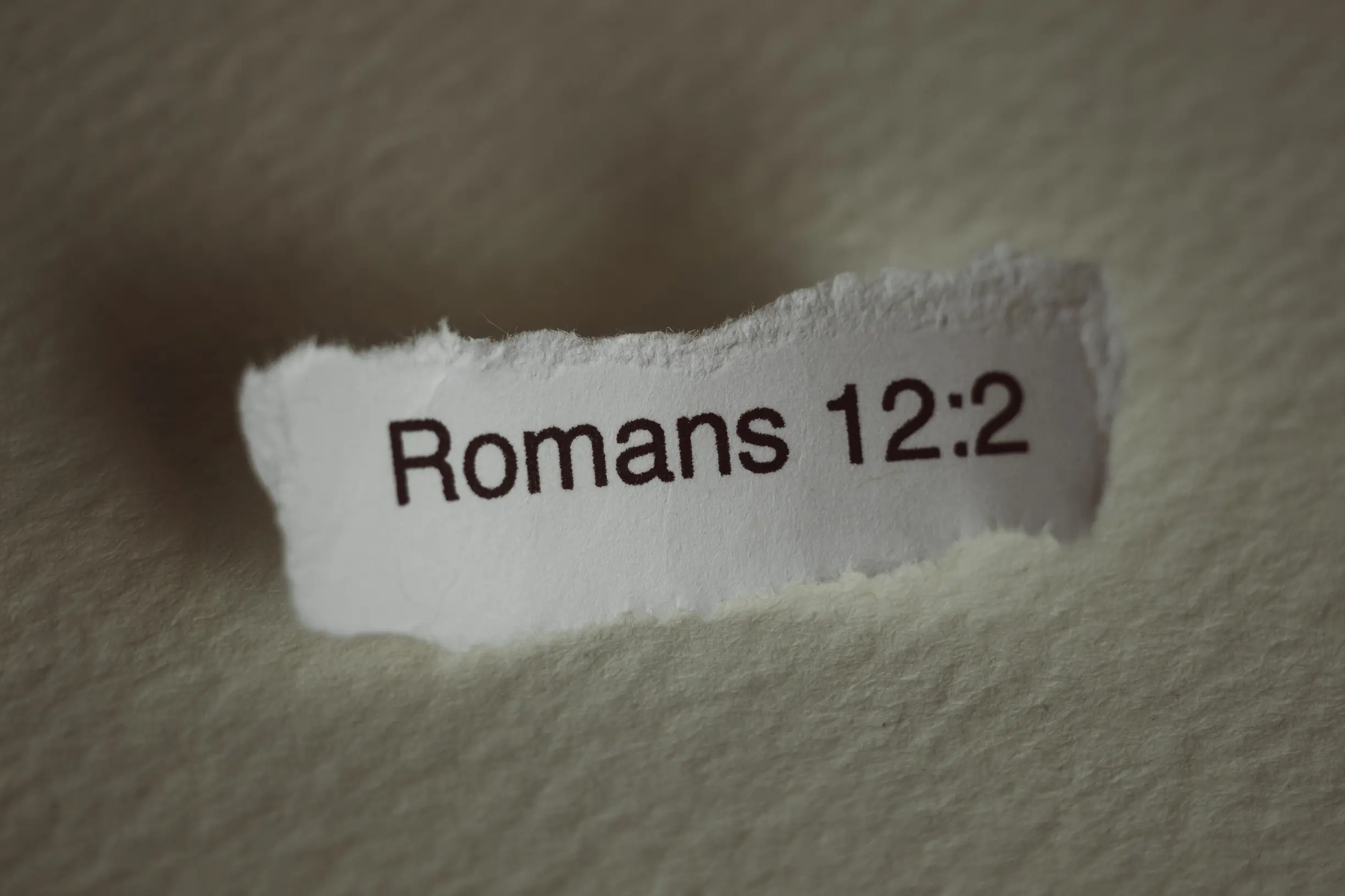 Image of Romans 12:2 on paper